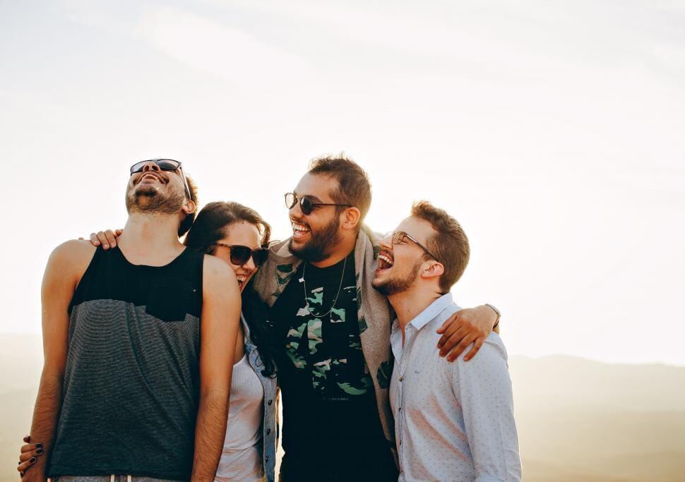 Diverse friends laughing together outdoors