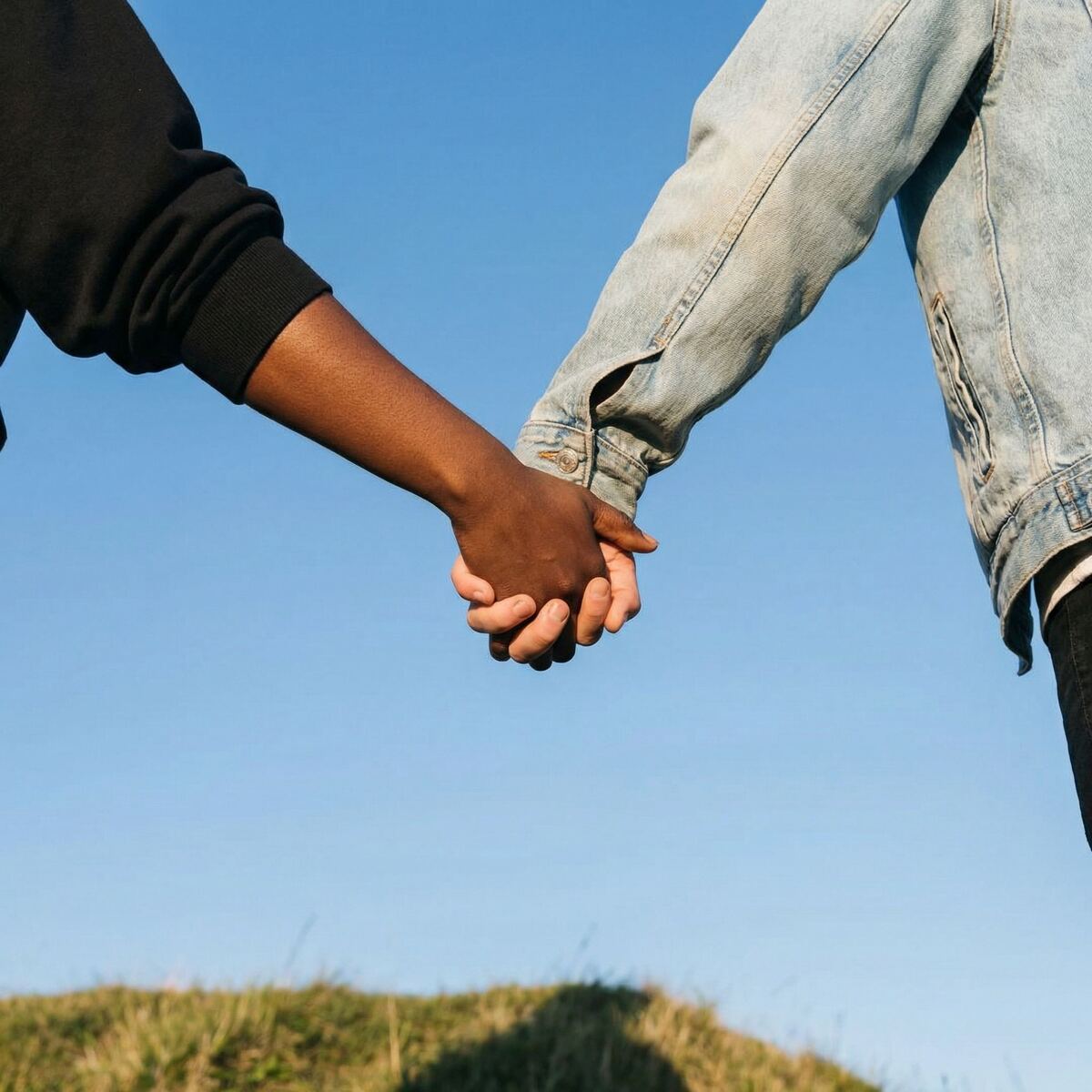 Interracial couple holding hands, aligned on their future together